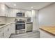 Bright kitchen featuring stainless steel appliances, white cabinets, and ample counter space at 14 Lockwood Dr # 11H, Charleston, SC 29401