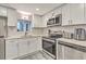 Modern kitchen with stainless steel appliances, white cabinets, and subway tile backsplash at 14 Lockwood Dr # 11H, Charleston, SC 29401