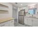 Well-lit kitchen features white cabinets, stainless steel refrigerator, and functional layout at 14 Lockwood Dr # 11H, Charleston, SC 29401
