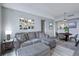 Bright living room features a comfortable gray couch, stylish decor, and an inviting dining area at 14 Lockwood Dr # 11H, Charleston, SC 29401