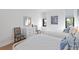 Sunlit bedroom with two twin beds, dresser, and decoratively patterned chairs at 14 Lockwood Dr # 2D, Charleston, SC 29401