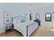 Serene bedroom with a wrought iron bed frame, light blue walls, and ample natural light at 14 Lockwood Dr # 2D, Charleston, SC 29401