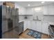 Bright, updated kitchen featuring stainless steel appliances, quartz counters, mosaic backsplash, and white cabinets at 14 Lockwood Dr # 2D, Charleston, SC 29401