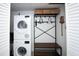 Modern laundry room with stacked washer and dryer, plus storage at 14 Lockwood Dr # 2D, Charleston, SC 29401