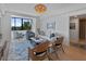 Beautiful living room with a large window view, white shiplap, stylish seating, and a woven light fixture at 14 Lockwood Dr # 2D, Charleston, SC 29401