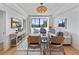 Bright living room with a water view, stylish furnishings, shiplap walls, and a woven pendant light at 14 Lockwood Dr # 2D, Charleston, SC 29401