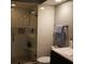 Updated bathroom features glass shower, white subway tile, and a dark vanity at 141 Marsh View Villas, Folly Beach, SC 29439