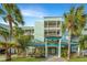 Inviting condo building with multiple balconies, lush landscaping, and coastal charm at 141 Marsh View Villas, Folly Beach, SC 29439