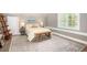 Well lit bedroom with neutral walls, light colored bedding, rug and wooden accents at 1516 Village Sq, Mount Pleasant, SC 29464