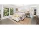 This is a stylish bedroom with a large window, wooden floors and a bench seat at 1516 Village Sq, Mount Pleasant, SC 29464