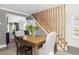 Bright dining area with a wooden table, seating, and stairs with modern wood railing at 1516 Village Sq, Mount Pleasant, SC 29464
