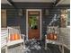 Inviting front porch with rocking chairs and decorative lanterns flanking the entry door at 1516 Village Sq, Mount Pleasant, SC 29464