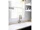 A close up view of the modern kitchen sink, white countertops and shelves at 1516 Village Sq, Mount Pleasant, SC 29464