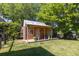 Charming wooden shed on a lush lawn with mature trees offering shade at 1516 Village Sq, Mount Pleasant, SC 29464