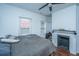 Simple bedroom with a bed, a decorative fireplace, and bright windows, offering a relaxed and inviting space at 152 Coming St St, Charleston, SC 29403
