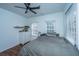 Cozy bedroom with a ceiling fan, a bed with gray bedding, and bright windows, creating a comfortable retreat at 152 Coming St St, Charleston, SC 29403