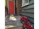 Charming wooden deck leads to a striking coral door, enhanced by vibrant flower arrangements at 152 Coming St St, Charleston, SC 29403