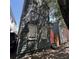 Charming, narrow two-story home with a striking coral door and beautifully textured dark green siding at 152 Coming St St, Charleston, SC 29403