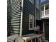 Charming exterior with dark wood siding and a small outdoor patio area with flower pots at 152 Coming St St, Charleston, SC 29403