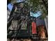 Charming, narrow two-story home with a striking coral door and beautifully textured dark green siding at 152 Coming St St, Charleston, SC 29403