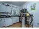 Well-lit kitchen with stainless steel appliances, white cabinets, and granite countertops, perfect for cooking and entertaining at 152 Coming St St, Charleston, SC 29403