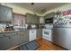 Traditional kitchen with gray cabinets, stainless steel refrigerator and white appliances at 152 Coming St St, Charleston, SC 29403
