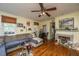 Cozy living room featuring hardwood floors, sectional sofa, and fireplace at 152 Coming St St, Charleston, SC 29403