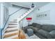 Bright living room with staircase, offering cozy seating and modern lighting, perfect for relaxation at 152 Coming St St, Charleston, SC 29403