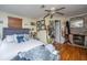 Spacious main bedroom featuring hardwood floors, fireplace and ceiling fan at 152 Coming St St, Charleston, SC 29403