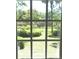 Bright backyard view through large window, showcasing lush greenery and serene outdoor space at 1527 S Pinebark Ln, Charleston, SC 29407