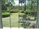 A view from inside featuring a well-maintained lawn and mature trees at 1527 S Pinebark Ln, Charleston, SC 29407