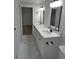 Bright bathroom with white cabinets, double sink vanity, quartz countertop, and modern fixtures at 1527 S Pinebark Ln, Charleston, SC 29407