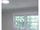 Bedroom with window offering natural light and a view of mature trees at 1527 S Pinebark Ln, Charleston, SC 29407