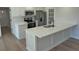 Kitchen view with island featuring quartz countertops, modern appliances, and white cabinets at 1527 S Pinebark Ln, Charleston, SC 29407