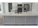 Close-up of the kitchen island featuring a quartz countertop, stainless steel sink, and ample space at 1527 S Pinebark Ln, Charleston, SC 29407