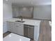Spacious kitchen with stainless steel dishwasher, quartz countertops, and white cabinetry at 1527 S Pinebark Ln, Charleston, SC 29407
