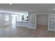 Open-concept living area featuring hardwood floors, modern lighting, and seamless flow to the kitchen at 1527 S Pinebark Ln, Charleston, SC 29407