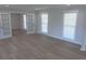Bright living space with hardwood floors, modern paint, and abundant natural light from large windows at 1527 S Pinebark Ln, Charleston, SC 29407