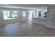 Bright, open-concept living space with hardwood floors, lots of natural light, and a view into the kitchen at 1527 S Pinebark Ln, Charleston, SC 29407