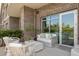 Inviting outdoor balcony with comfortable seating, white furniture, and brick building exterior at 155 Wingo Way # 415, Mount Pleasant, SC 29464