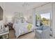 Comfortable bedroom featuring a cozy chair, bright window view, and a stylish coastal aesthetic at 155 Wingo Way # 415, Mount Pleasant, SC 29464