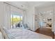 Bright bedroom with balcony access, chair, and view of sitting area through the door at 155 Wingo Way # 415, Mount Pleasant, SC 29464