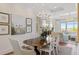 Refined dining space with a beautiful wood table, stylish chairs, modern chandelier, and an open flow to the living area at 155 Wingo Way # 415, Mount Pleasant, SC 29464
