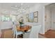 Elegant dining room featuring hardwood floors, a modern chandelier, and stylishly upholstered chairs at 155 Wingo Way # 415, Mount Pleasant, SC 29464
