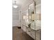 Elegant hallway features stylish console table with lamps and mirror, complemented by wainscoting and tile floors at 155 Wingo Way # 415, Mount Pleasant, SC 29464