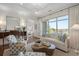 Sophisticated living room featuring a decorative coffee table, plush seating, and access to a scenic balcony at 155 Wingo Way # 415, Mount Pleasant, SC 29464