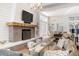 Bright living room with a brick fireplace, large TV, and comfortable sofas at 155 Wingo Way # 415, Mount Pleasant, SC 29464