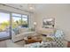 Bright living room with stylish decor, a modern sofa, unique coffee table, and scenic balcony view at 155 Wingo Way # 415, Mount Pleasant, SC 29464