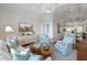 Inviting living room featuring stylish decor, blue patterned chairs, and a glimpse of the dining area at 155 Wingo Way # 415, Mount Pleasant, SC 29464