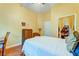 Inviting bedroom with yellow walls, wooden floors, and a doorway that allows natural light in at 1832 Telfair Way # 1832, Charleston, SC 29412
